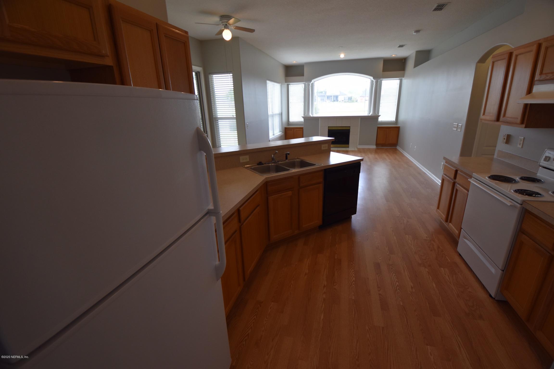 2473 Shelby Creek Road West Jacksonville, FL 32221 - Photo 6 of 9 a kitchen with granite countertop a refrigerator a stove top oven a sink and dishwasher
