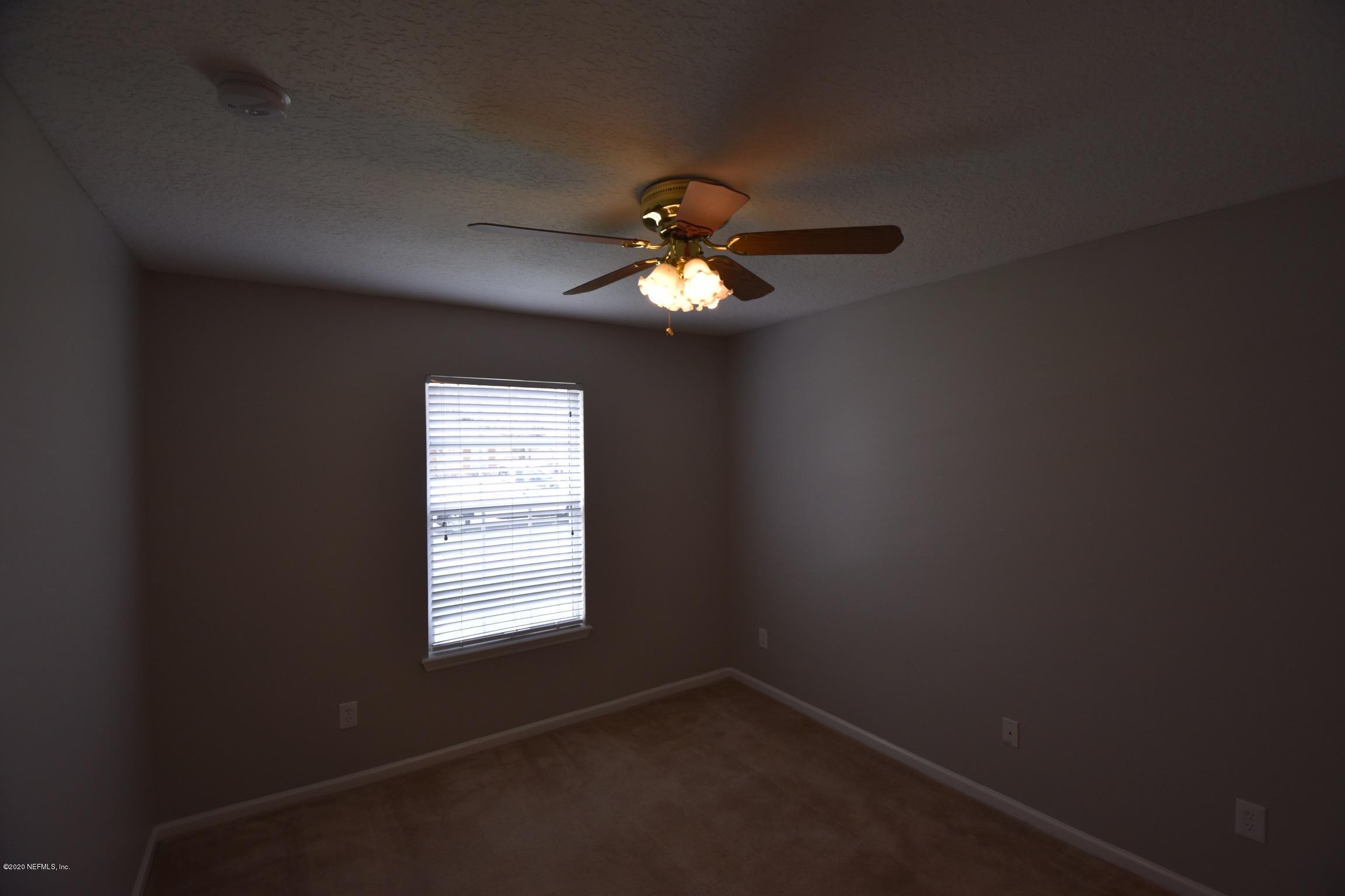 2473 Shelby Creek Road West Jacksonville, FL 32221 - Photo 7 of 9 a room with a window and a chandelier fan