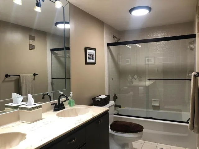 a bedroom with a bed and a mirror