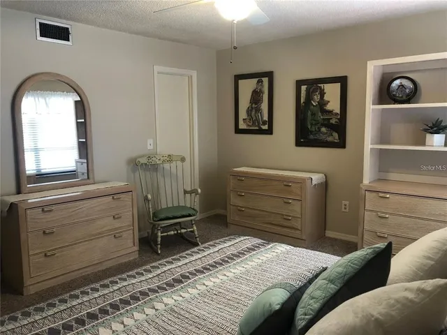 a bathroom with a granite countertop sink a toilet and a mirror