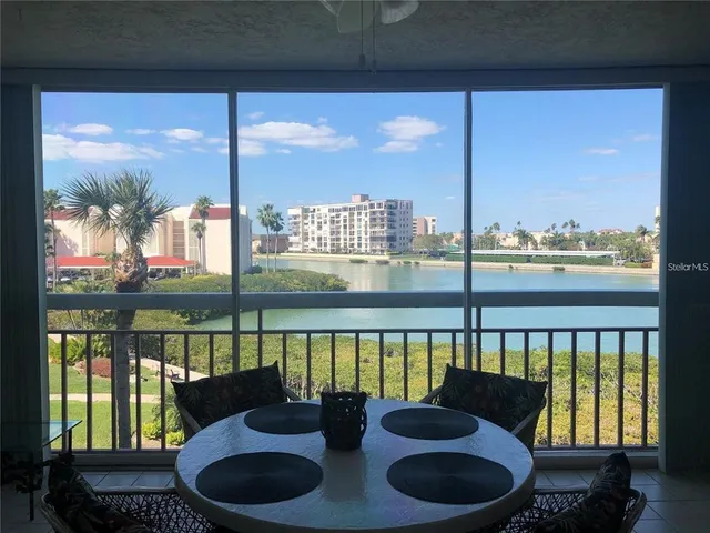 a living room with furniture painting on wall and a lamp