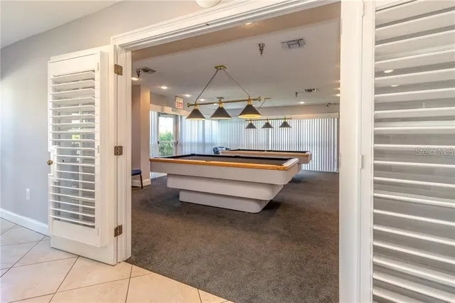 a view of a livingroom with furniture and a bookshelf