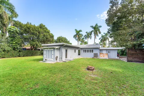a view of a house with a yard and sitting area