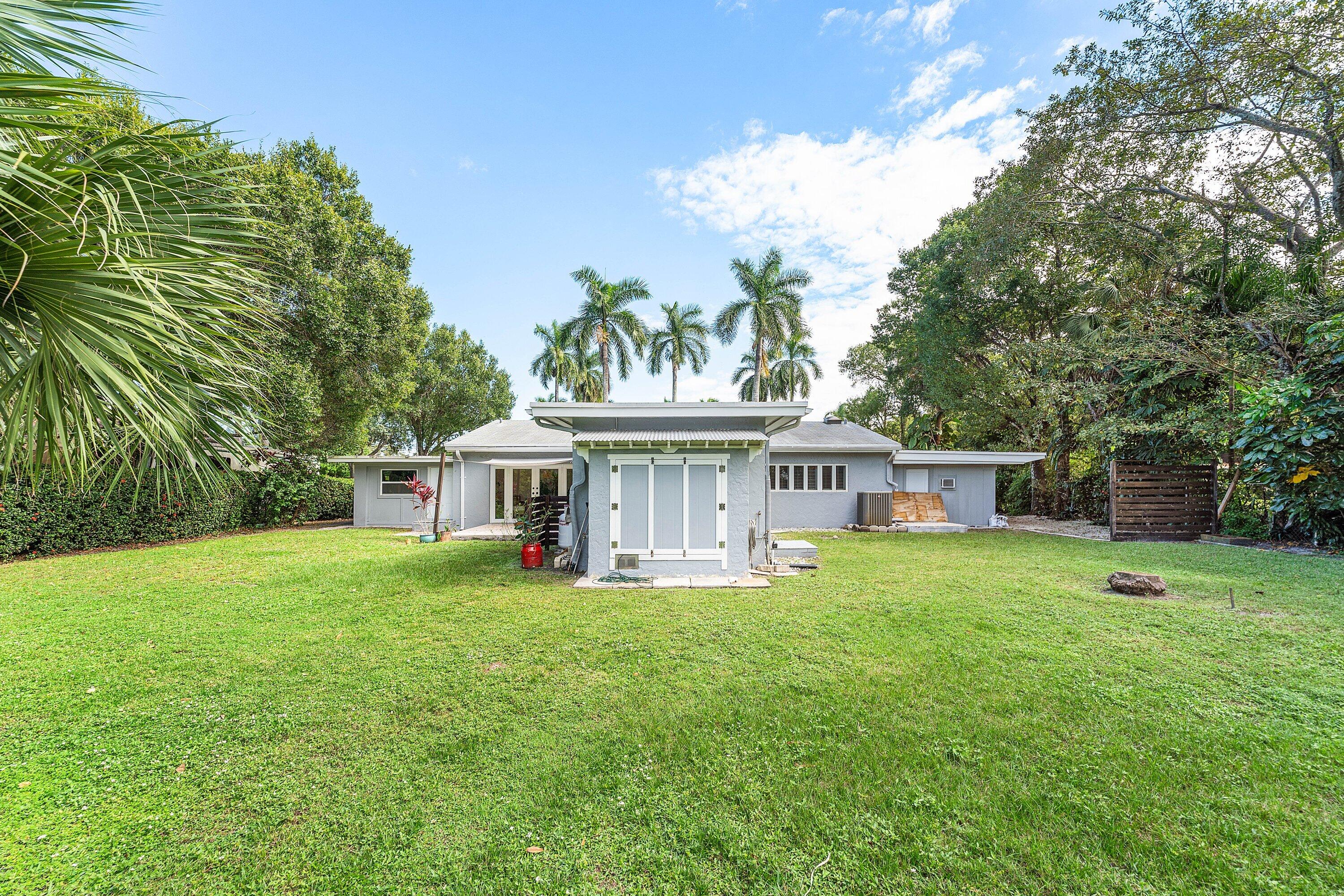 2573 Southwest 30th Terrace Fort Lauderdale, FL 33312 - Photo 16 of 44 a view of a house with a big yard and potted plants and large trees