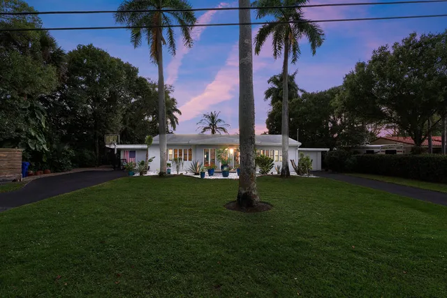 a front view of a house with a garden