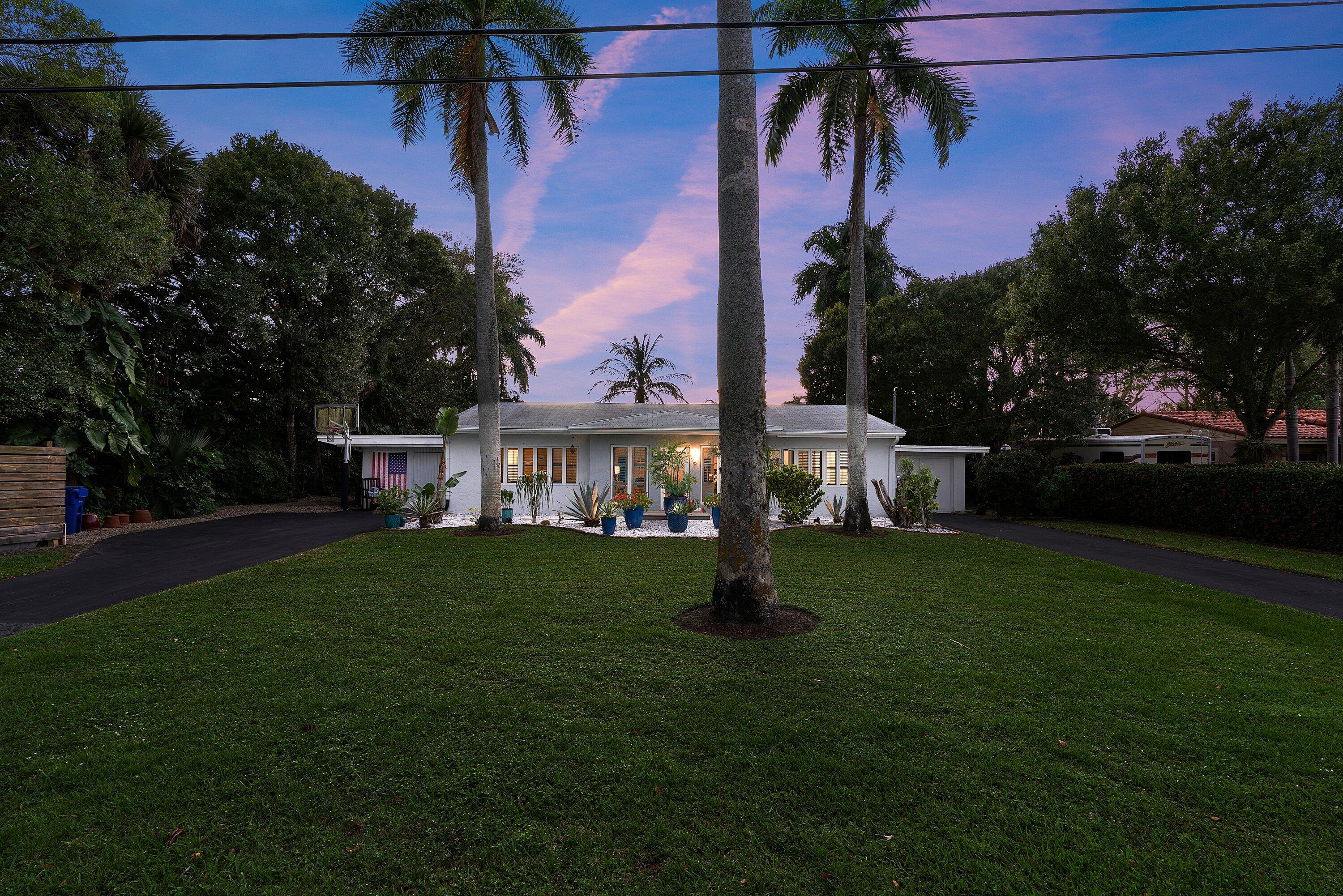 2573 Southwest 30th Terrace Fort Lauderdale, FL 33312 - Photo 2 of 44 a front view of a house with a garden