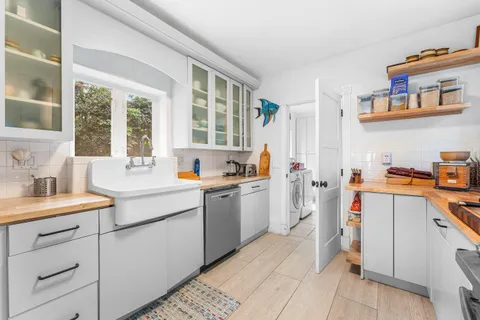 a kitchen that has a sink and a stove in it