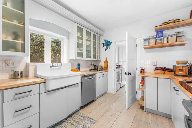a kitchen that has a sink and a stove in it