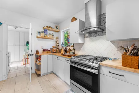 a kitchen with stainless steel appliances granite countertop a stove and a sink
