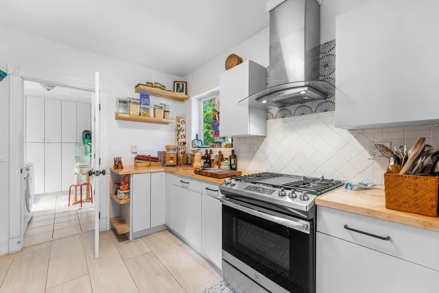 a kitchen with stainless steel appliances granite countertop a stove and a sink