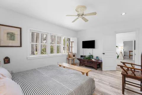 a bedroom with a bed and wooden floor