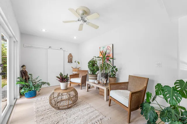 a living room with furniture potted plant and a window