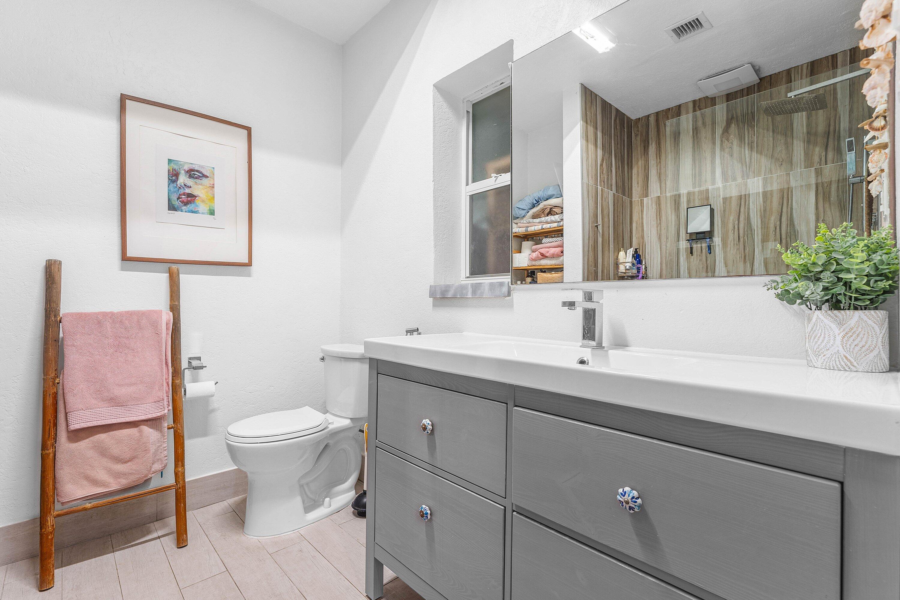 2573 Southwest 30th Terrace Fort Lauderdale, FL 33312 - Photo 40 of 44 a bathroom with a sink toilet and a mirror