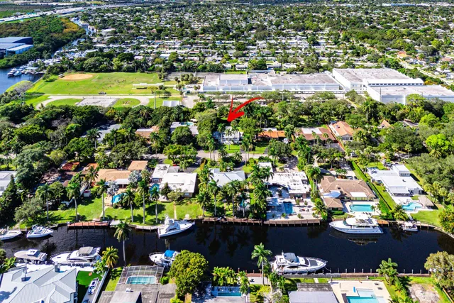 an aerial view of a houses with a yard and green space
