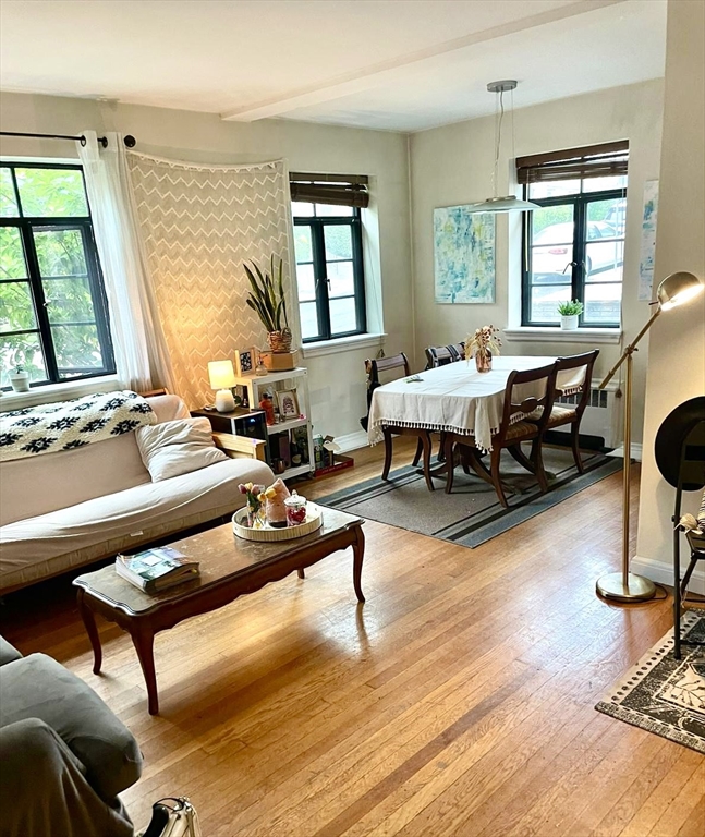 a living room with furniture pool table and a window