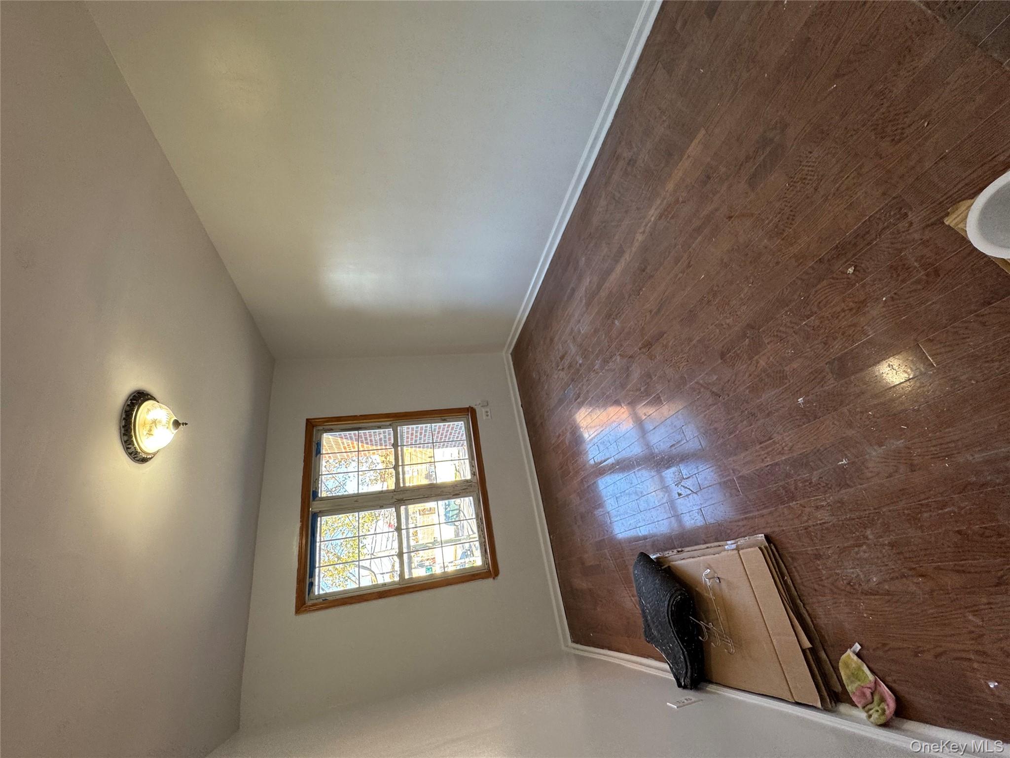 62-21 Dry Harbor Road Queens, NY 11379 - Photo 1 of 1 an empty room with windows