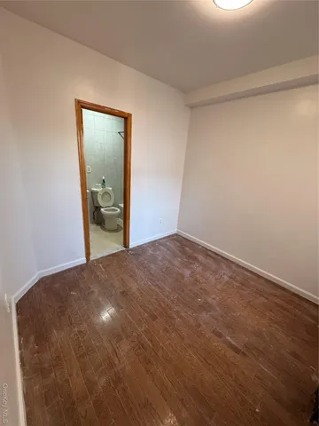 a view of an empty room and closet area