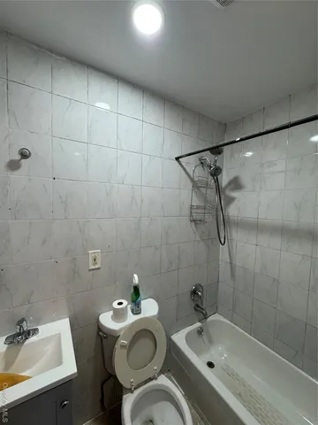 a bathroom with a sink mirror toilet and shower