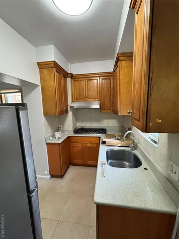 a kitchen with a sink a stove and a refrigerator