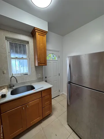 a kitchen with stainless steel appliances granite countertop a sink a refrigerator and a granite counter tops