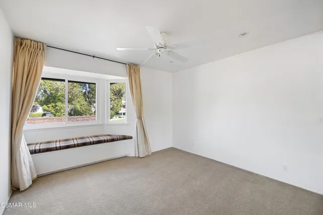 an empty room with a large window and outdoor view