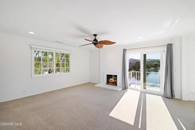 a view of a living room hardwood floor and a large window