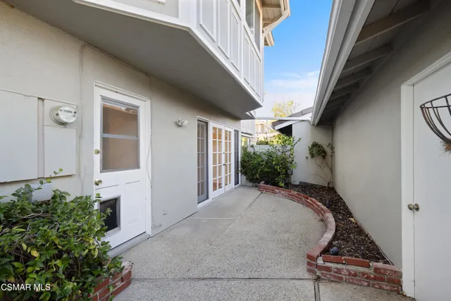 a view of a backyard with potted plants