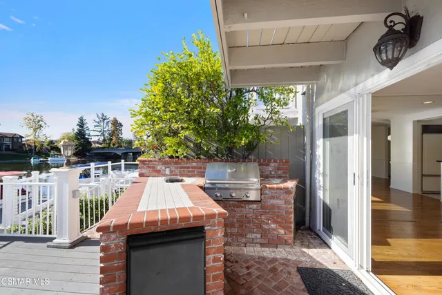 a view of a patio with table and chairs with wooden floor and fence