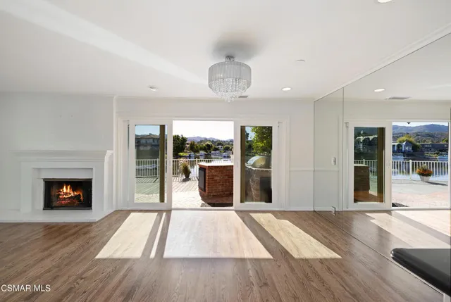 a view of a living room a window and wooden floor