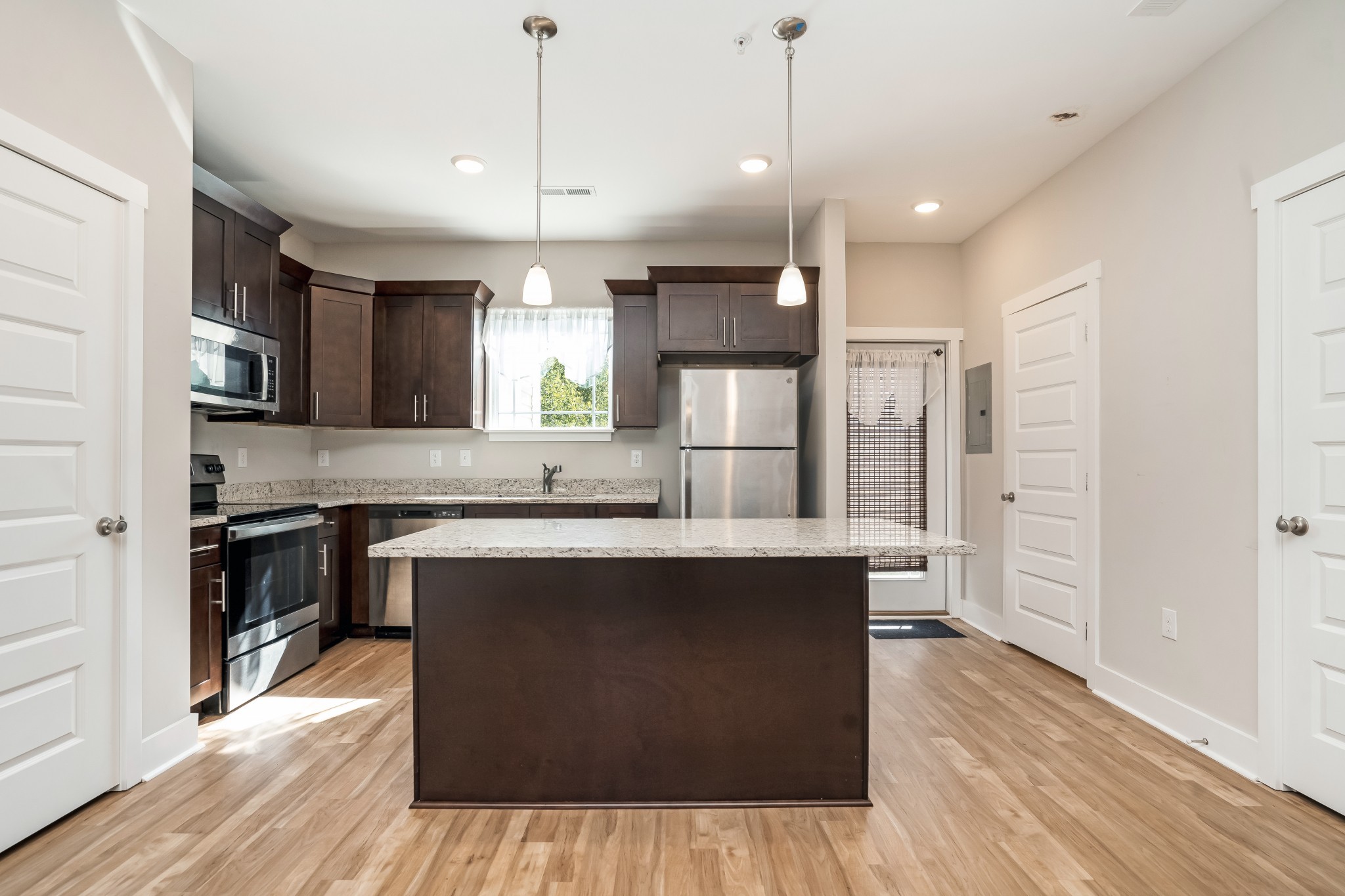 4012 Angelica Ct Spring Hill, Unit 4012 Spring Hill, TN 37174 - Photo 2 of 12 a kitchen with stainless steel appliances granite countertop a sink a stove and a wooden floors
