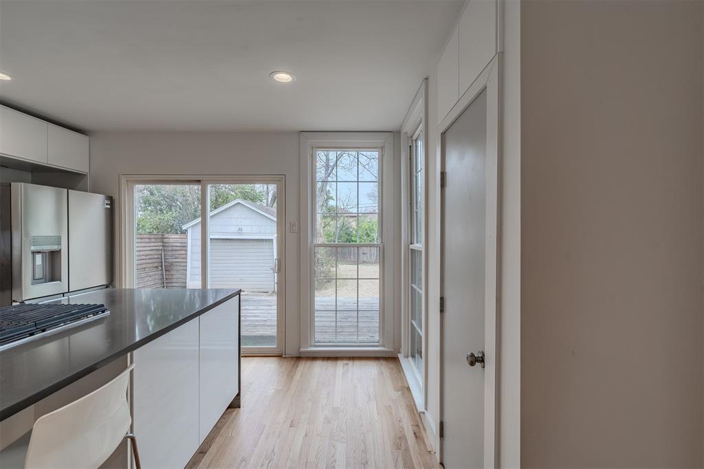 8927 Diceman Drive Dallas, TX 75218 - Photo 12 of 33 a view of hallway with wooden floor and fan