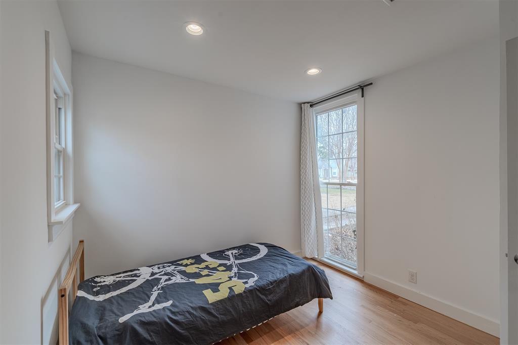 8927 Diceman Drive Dallas, TX 75218 - Photo 24 of 33 a bedroom with a bed and a window
