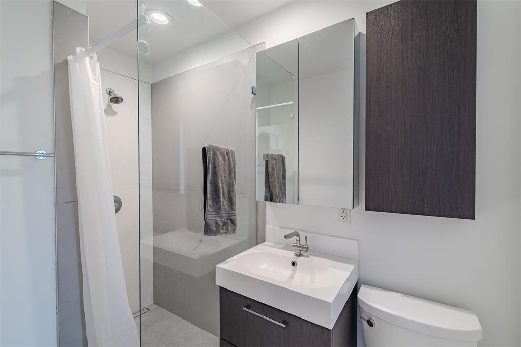 8927 Diceman Drive Dallas, TX 75218 - Photo 25 of 33 a bathroom with a sink toilet and mirror