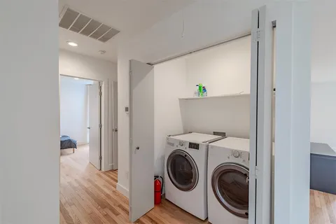 a view of a hallway with washer and dryer