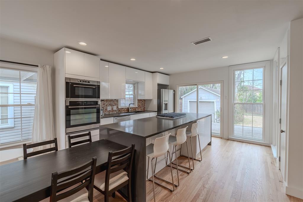 8927 Diceman Drive Dallas, TX 75218 - Photo 5 of 33 a kitchen with stainless steel appliances granite countertop a stove top oven a sink and a refrigerator