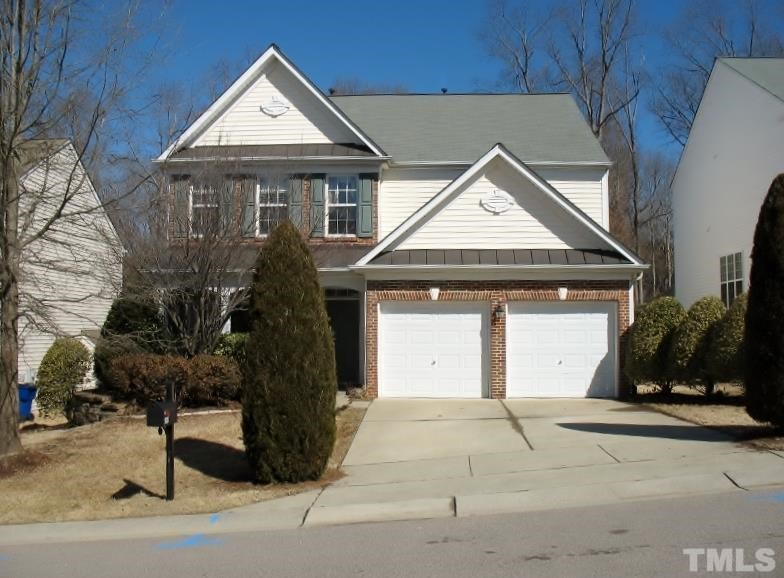 5328 Shaker Heights Lane Raleigh, NC 27613 - Photo 1 of 25 a front view of a house with a yard and garage