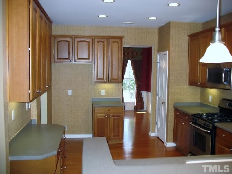 5328 Shaker Heights Lane Raleigh, NC 27613 - Photo 12 of 25 a kitchen with stainless steel appliances granite countertop a refrigerator and a stove top oven