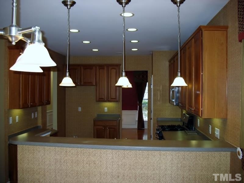 5328 Shaker Heights Lane Raleigh, NC 27613 - Photo 14 of 25 a room with lots of furniture and a chandelier