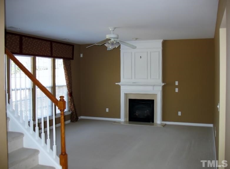 5328 Shaker Heights Lane Raleigh, NC 27613 - Photo 15 of 25 a view of a livingroom with an empty space and a fireplace