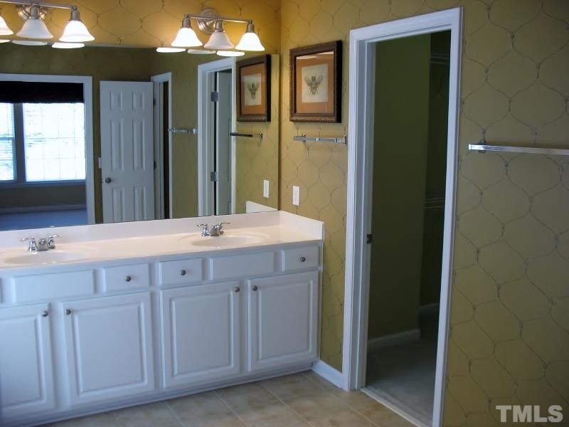 5328 Shaker Heights Lane Raleigh, NC 27613 - Photo 21 of 25 a bathroom with a double vanity sink and a mirror