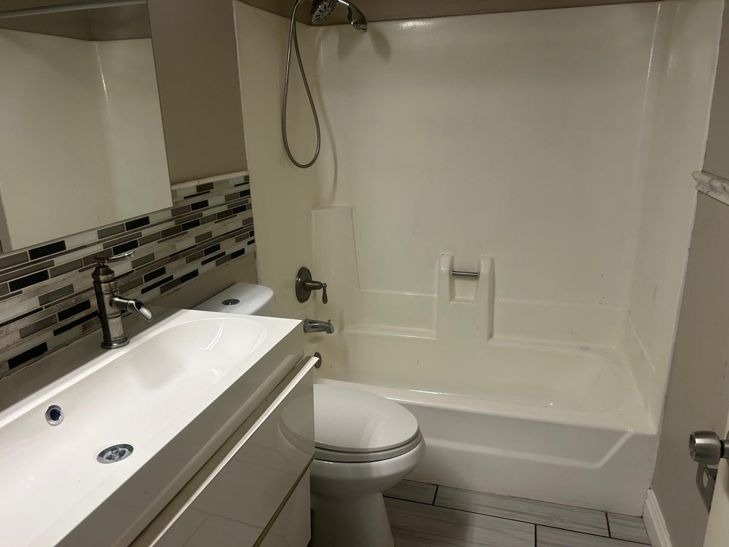 1320 West 3rd Street, Unit 2 Tempe, AZ 85281 - Photo 5 of 10 a bathroom with a granite countertop toilet sink and shower