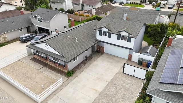 an aerial view of a house with a backyard