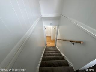 19372 Sunderland Road Detroit, MI 48219 - Photo 18 of 34 Carpeted staircase with light wood handrail and light gray wall paint