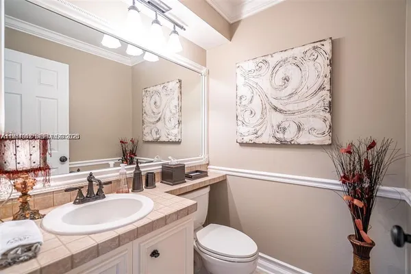 a bathroom with a toilet a sink and a mirror