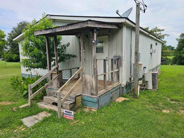 an front view of a house with a yard