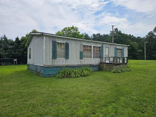 a view of a house with a backyard
