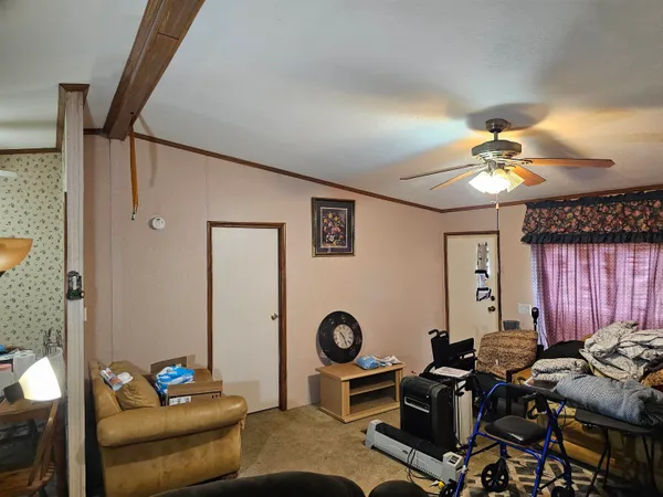 a living room with furniture and a chandelier