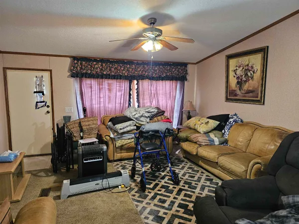 a living room with furniture a chandelier and a window