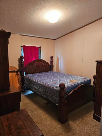 a bedroom with a bed and window