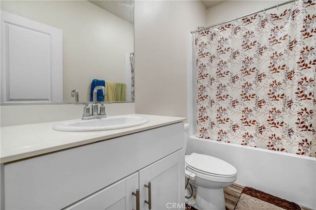 24871 Tiger Avenue Moreno Valley, CA 92551 - Photo 5 of 13 a bathroom with a sink toilet and mirror